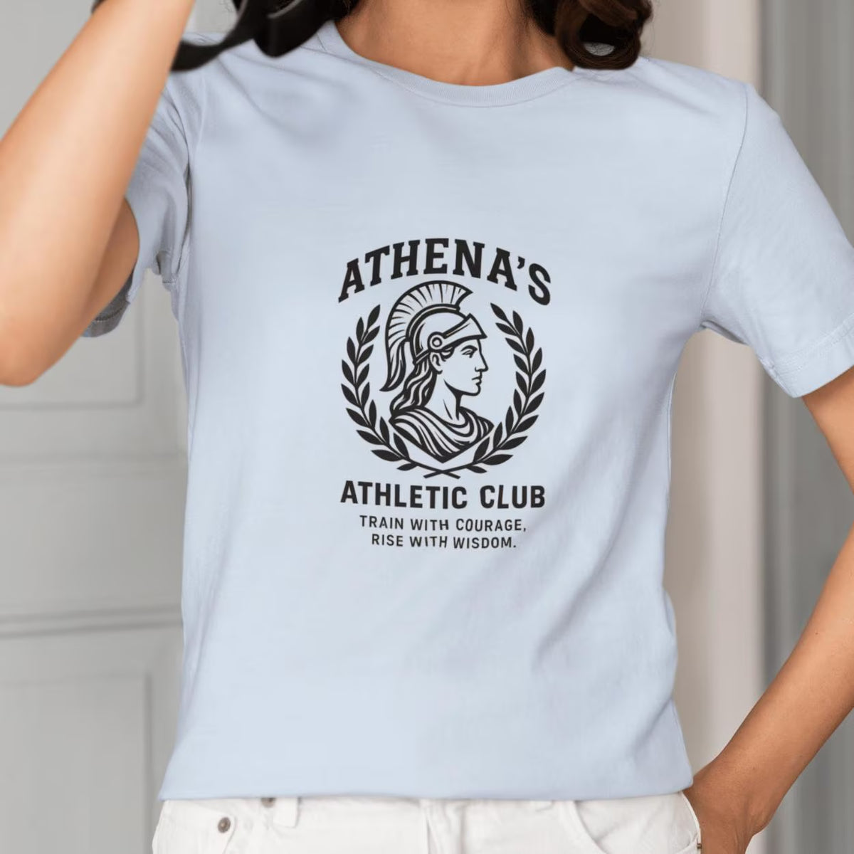 Athena's Athletic Club Greek mythology t-shirt in light blue, front print of a helmeted Athena in a laurel wreath with the words Train with courage, rise with wisdom