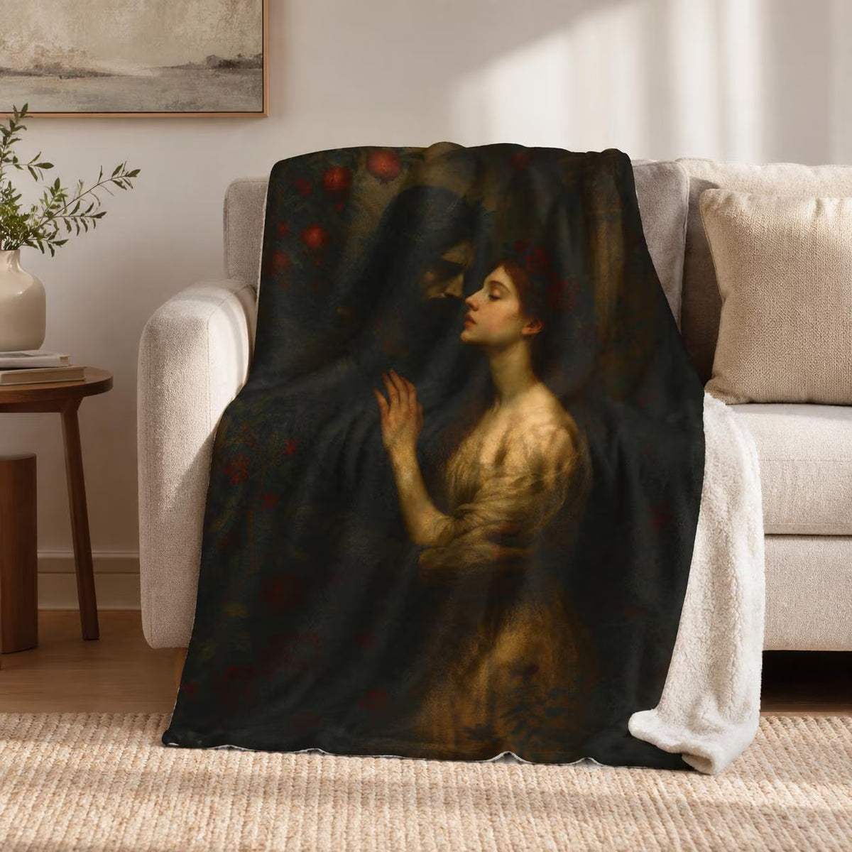 Hades and Persephone plush blanket depicting the underworld couple among pomegranate blossoms, draped over a sofa